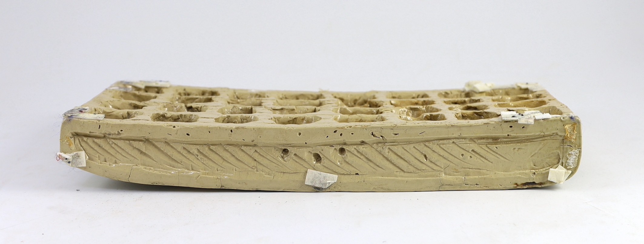 A rare Martin Brothers 'Wheel Boy, Bench Boy and Thrower' stoneware plaque, dated 1882, 41cm wide 17.5cm high